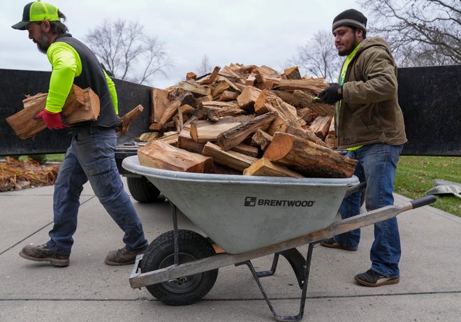 Dustin Brown (left) and Henry Lopez deliver three ricks of kiln-dried wood on Thursday, Jan. 4, 2024, in Zionsville. The two work for local company Haulstr, which does a variety of things from mulch delivery to custom patio builds. In the slower winter months, firewood helps keep the lights on.