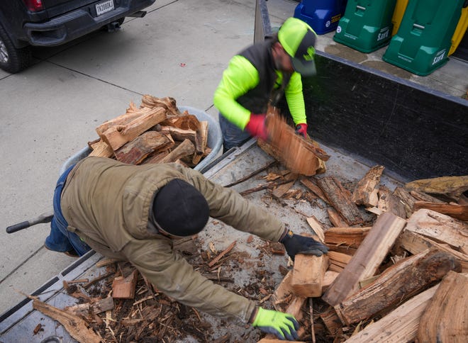 Dustin Brown (left) and Henry Lopez deliver three ricks of kiln-dried wood on Thursday, Jan. 4, 2024, in Zionsville. The two work for local company Haulstr, which donates part of each sale to a variety of local charities.
