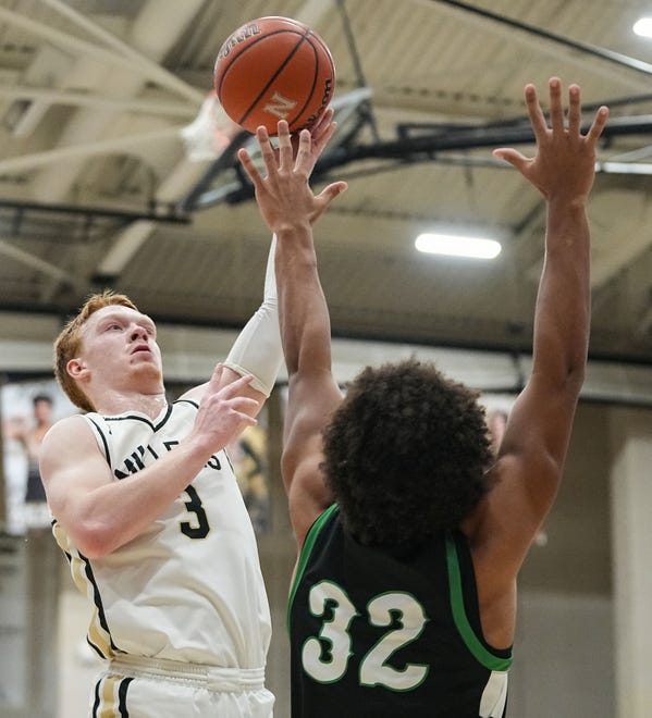 Noblesville Millers guard Aaron Fine (3) goes in for a lay-up against Westfield Shamrocks forward Carsen Melvin (32) on Wednesday, Jan. 17, 2024, during the game at Noblesville High School in Noblesville. The Westfield Shamrocks defeated the Noblesville Millers, 58-54.