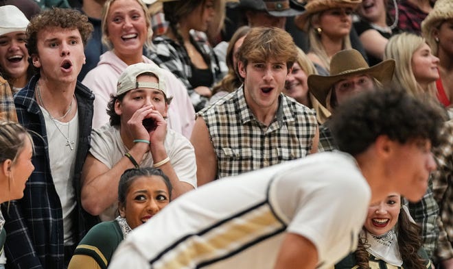 Westfield Shamrocks students yell at Noblesville Millers guard Justin Curry II (10) on Wednesday, Jan. 17, 2024, during the game at Noblesville High School in Noblesville. The Westfield Shamrocks defeated the Noblesville Millers, 58-54.