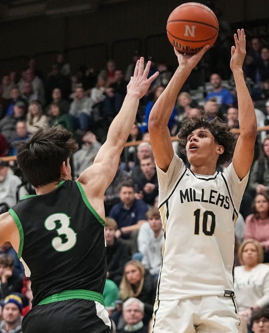 Noblesville Millers guard Justin Curry II (10) shoots the ball against Westfield Shamrocks Trey Buchanan (3) on Wednesday, Jan. 17, 2024, during the game at Noblesville High School in Noblesville. The Westfield Shamrocks defeated the Noblesville Millers, 58-54.