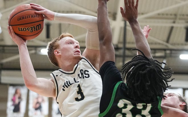 Noblesville Millers guard Aaron Fine (3) goes in for a lay-up against Westfield Shamrocks forward Durante Morton (33) on Wednesday, Jan. 17, 2024, during the game at Noblesville High School in Noblesville. The Westfield Shamrocks defeated the Noblesville Millers, 58-54.