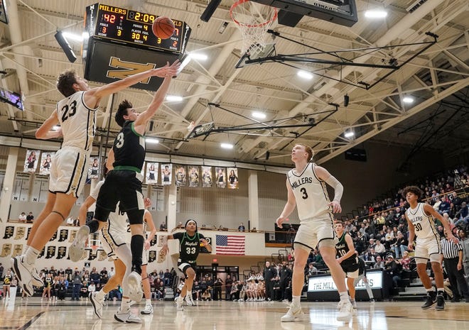 Noblesville Millers guard Luke Etchison (23) attempts to block Westfield Shamrocks Trey Buchanan (3) on Wednesday, Jan. 17, 2024, during the game at Noblesville High School in Noblesville. The Westfield Shamrocks defeated the Noblesville Millers, 58-54.