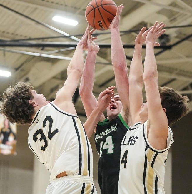 Westfield Shamrocks forward Nic Book (24) shoots the ball against Noblesville Millers forward Will Smits (32) on Wednesday, Jan. 17, 2024, during the game at Noblesville High School in Noblesville. The Westfield Shamrocks defeated the Noblesville Millers, 58-54.