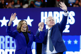 US Vice President and 2024 Democratic presidential candidate Kamala Harris and her running mate Minnesota Governor Tim Walz wave to the crowd after speaking at the campaign rally at the Fiserv Forum in Milwaukee, Wisconsin, August 20, 2024.